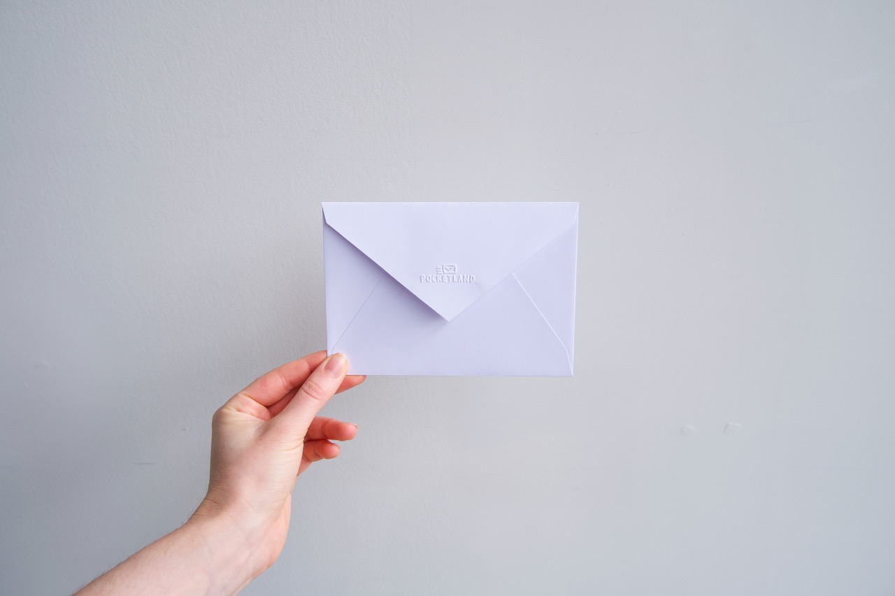 White C6 envelope held in hand